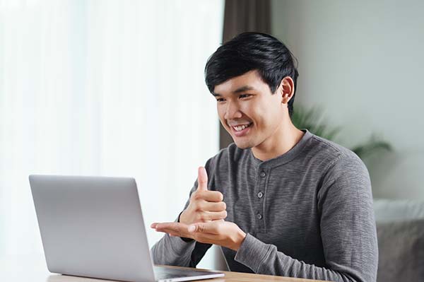 A blind man uses a computer with a Braille display and a computer keyboard. Inclusive device